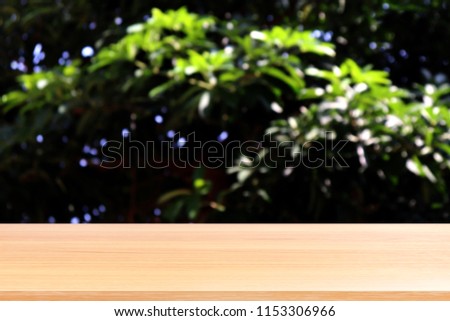 empty wood table floors on blurred tree nature green forest background, wood table board empty front blur tree, wooden plank blank with perspective brown wood table for mock up display products