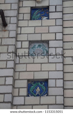 colored tiles on the walls of buildings