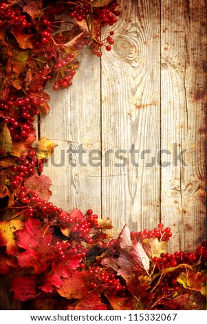 Vintage Autumn border from ashberry and  and fallen leaves on old wooden table/Thanksgiving day concept/