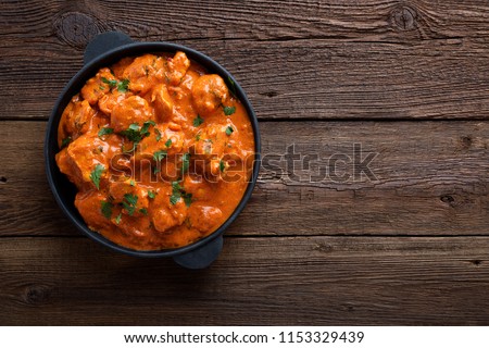 Tasty butter chicken curry dish from Indian cuisine. Royalty-Free Stock Photo #1153329439