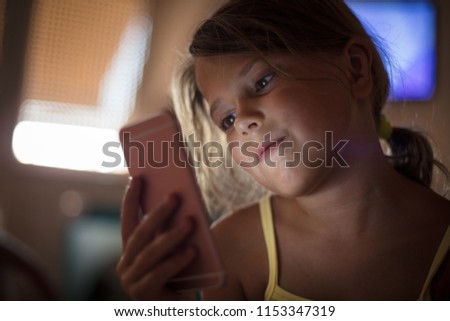 Little girl using smart phone. Copy space. Close up.