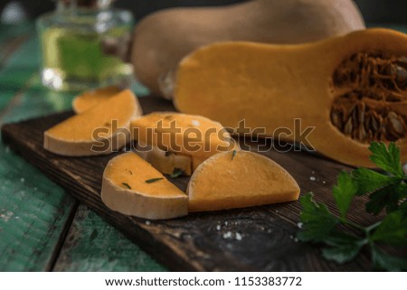 butternut squash over old wood background, Pumpkin pieces, harvest, fall. Dark brown background. Cooking in autumn. Healthy food.