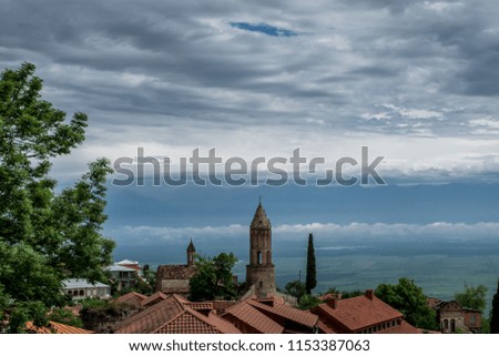 Beautiful view of the old town with red roofs. Sighnaghi, Georgia. Spring or summer cloudy sky.