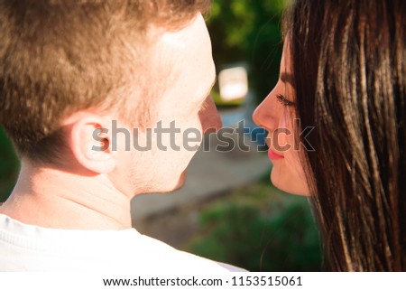 Portrait of the young happy romantic couple who standing in embrace outdoor.