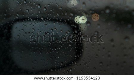 closed rain drops on car glass with side glass and bokehs