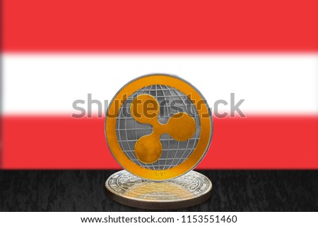 Ripple XRP on cryptocurrency coin with Austrian flag in background. The cryptocurrency coin is golden and in focus. This is an Austria Ripple concept.