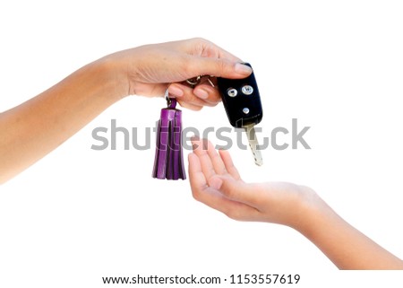 hand holding car key  and give to other hand isolated on white