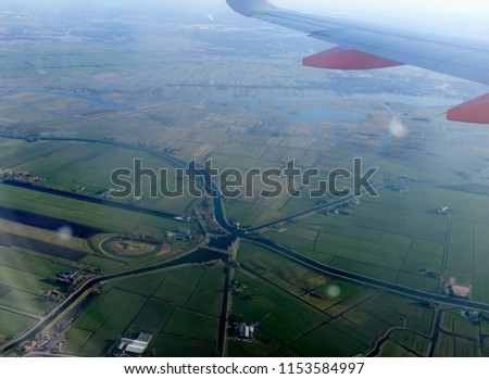 City view from the plane. View from airplane window on the wing Holland Amsterdam Port Plane wing