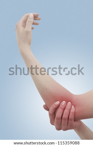 Acute pain in a woman elbow. Female holding hand to spot of elbow pain. Concept photo with Color Enhanced skin with read spot indicating location of the pain. Isolation on a white background.