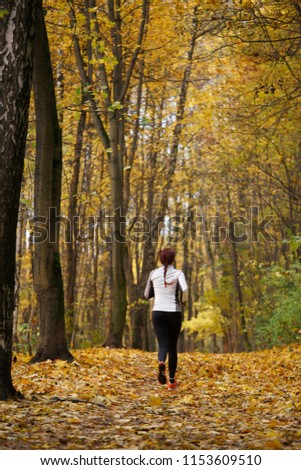 Photo from back in full growth of brunette on morning run