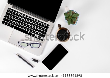 Office table with laptop computer, smartphone, pen, notebook and coffee on isolated pure white background / Laptop and tablet mockup concept. (Selective Focus)