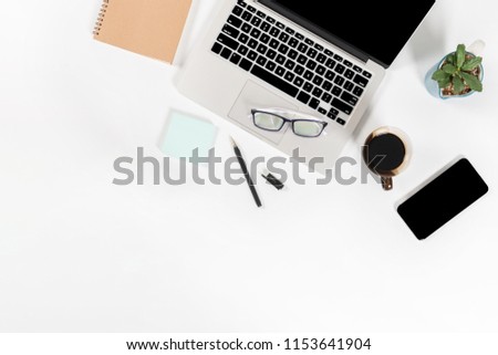 Office table with laptop computer, smartphone, pen, notebook and coffee on isolated pure white background / Laptop and tablet mockup concept. (Selective Focus)