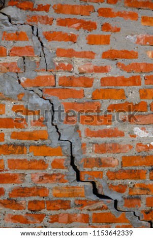 Old brick wall with a crack diagonally