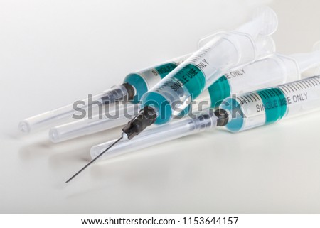 Several syringe on white table prepared for injection in hospital Royalty-Free Stock Photo #1153644157