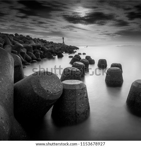 light house on a breakwater at Chendering Beach, located in Terengganu, Malaysia. long exposure photography,Soft focus effect.black and white photography