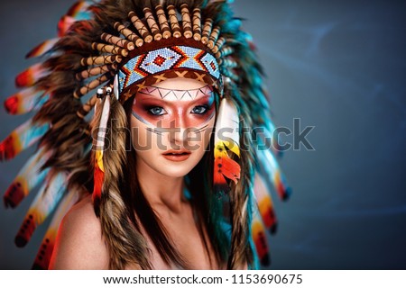 Beautiful young woman with big American Indian plume of feathers background