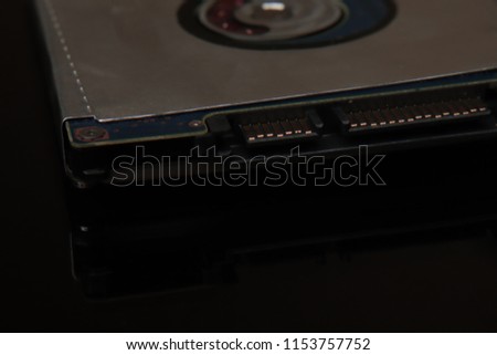 Hard disk for laptop storage data on black black background with reflection. New technology is ahead of us.
