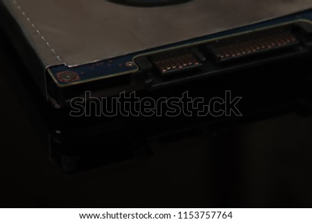 Hard disk for laptop storage data on black black background with reflection. New technology is ahead of us.