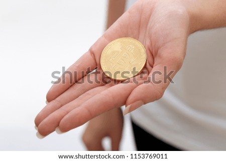 Close up of Bitcoin in hand for cryptocurrency concept on white background