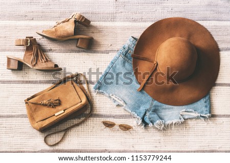Be in trend. Denim shorts, suede bag, stylish sandals, glasses and hat. Beige color. Flat lay