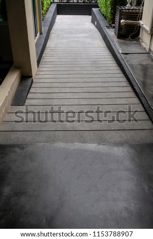 Ramped access, using wheelchair ramp with information sign on floor background for disabled people.