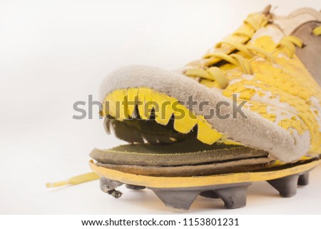 Old bad football boots take a picture in the background behind a white background.