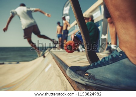Skate contest on summer sports festival. Skateboarders skating on a mini ramp 