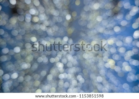 Abstract blue bokeh circles for Christmas background. Royalty high-quality free stock photo of Christmas light overlay background. Holiday glowing backdrop. Defocused background with blinking stars