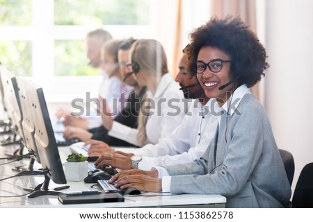 Portrait Of A Smiling African Female Customer Service Executive Royalty-Free Stock Photo #1153862578