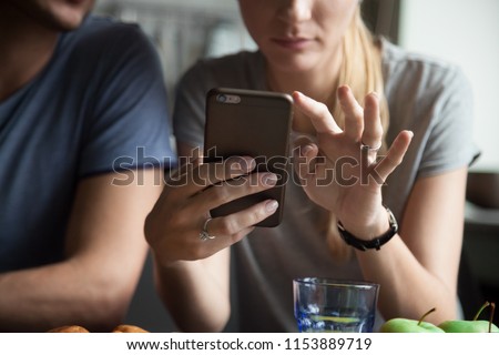 Woman holding mobile phone using smartphone apps concept, couple customers shopping, texting message, searching information online, checking social networks, banking, making order on cell, close up