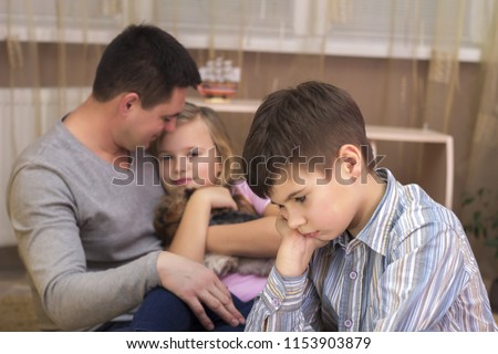 The boy is jealous of his father's sister and sad Royalty-Free Stock Photo #1153903879