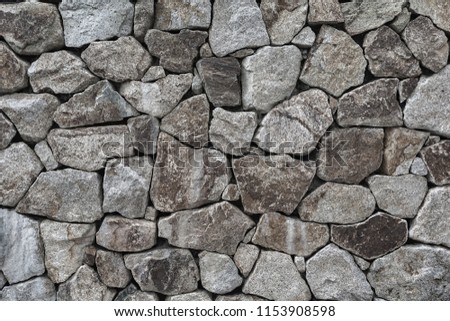 Old grunge stone vintage style stones wall seamless background and texture.