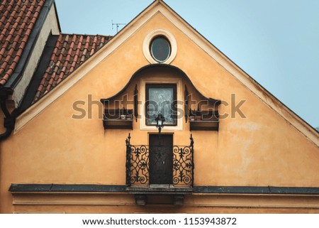 Vintage cute balcony in Praha.  Simplicity in detail. Yellow house. Blue sky and pretty view. 