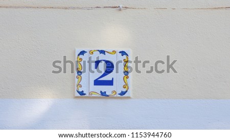 ceramics house number on the wall two
