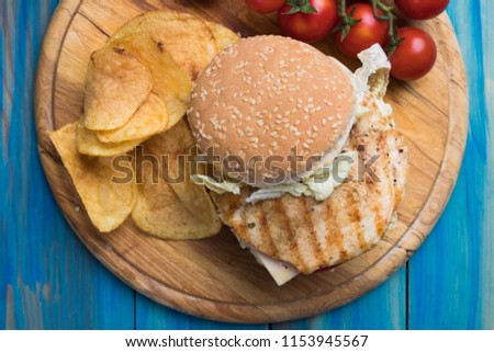 Sandwich with grilled chicken steak meat, tomato and lettuce