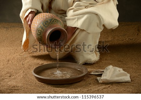 Jesus with a jug of water and a towel on a neutral background Royalty-Free Stock Photo #115396537