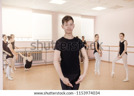 warm-up sessions at the bench, the girls doing ballet.three young girls with gathered hair and black bodysuits are engaged near the ballet bar