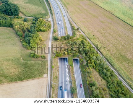 Aerial view of wildlife overpass over highway in Switzerland dur Royalty-Free Stock Photo #1154003374