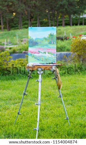 Etude oil on the easel in the botanical garden at sunset