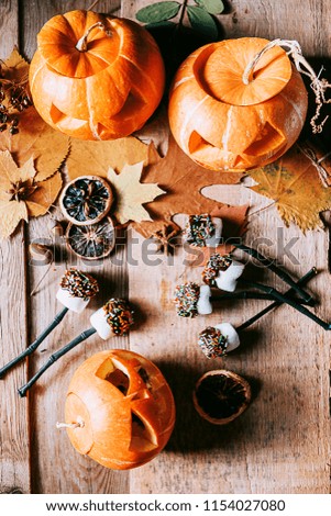 marshmallow stylized to celebrate halloween on a pumpkin background