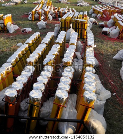 Preparation of big firework with tubes filled with gunpowder and electric wire on ground.