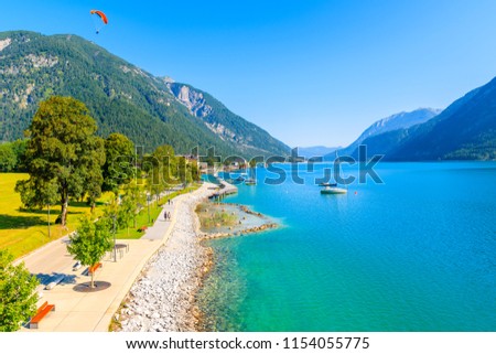 Shore of beautiful Achensee lake on sunny summer day with blue sky, Karwendel mountain range, Tyrol, Austria Royalty-Free Stock Photo #1154055775