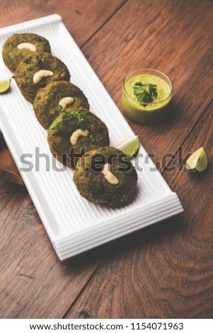 Hara bhara Kabab or Kebab is Indian vegetarian snack recipe served with green mint chutney over moody background. selective focus