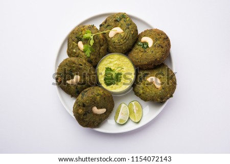 Hara bhara Kabab or Kebab is Indian vegetarian snack recipe served with green mint chutney over moody background. selective focus Royalty-Free Stock Photo #1154072143