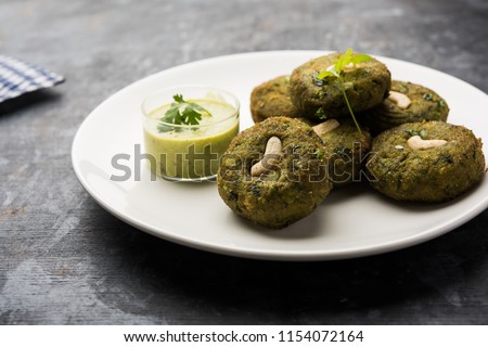 Hara bhara Kabab or Kebab is Indian vegetarian snack recipe served with green mint chutney over moody background. selective focus Royalty-Free Stock Photo #1154072164
