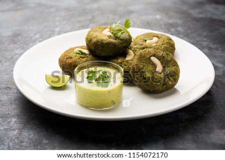 Hara bhara Kabab or Kebab is Indian vegetarian snack recipe served with green mint chutney over moody background. selective focus Royalty-Free Stock Photo #1154072170