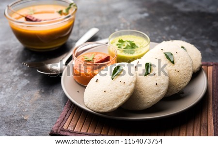 Idly sambar or Idli with Sambhar and green, red chutney. Popular South indian breakfast Royalty-Free Stock Photo #1154073754