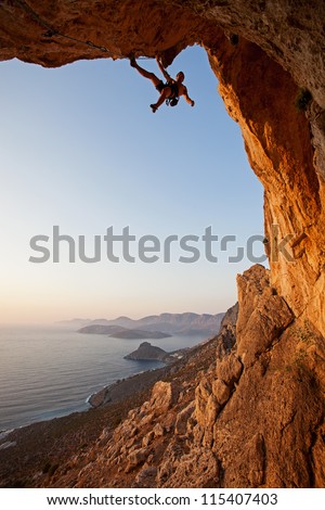 Rock climber at sunset, Kalymnos Island, Greece Royalty-Free Stock Photo #115407403