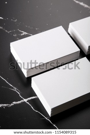 Photo of white business cards on black marble. Template for branding identity isolated on marble background. For graphic designers presentations and portfolios marble premium luxury mock-up. 