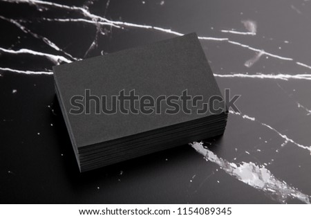 Photo of black business cards on black marble. Template for branding identity isolated on marble background. For graphic designers presentations and portfolios marble premium luxury mock-up. 